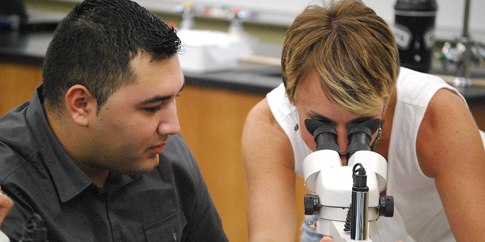 Professor and Student with Microscope